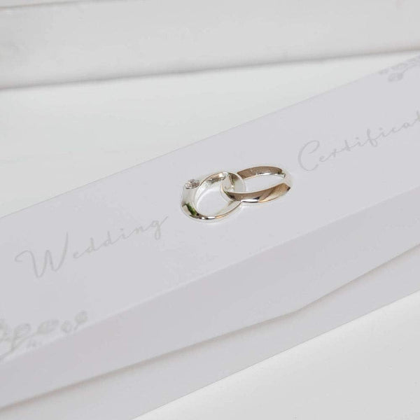 Two interlocking wedding rings on a white card with 'Wedding Rings' text.