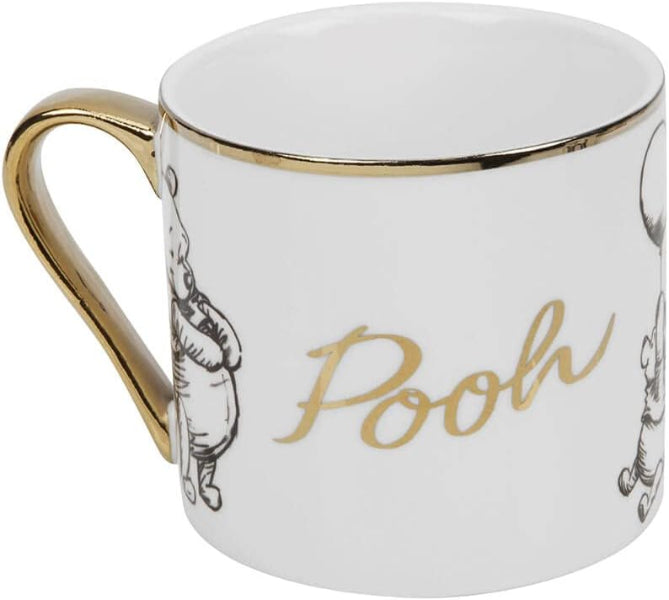 White mug with gold rim and 'Pooh' text, featuring a cartoon character on a white background