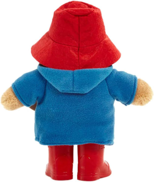 Plush toy with red hat, blue coat, and red boots on a white background