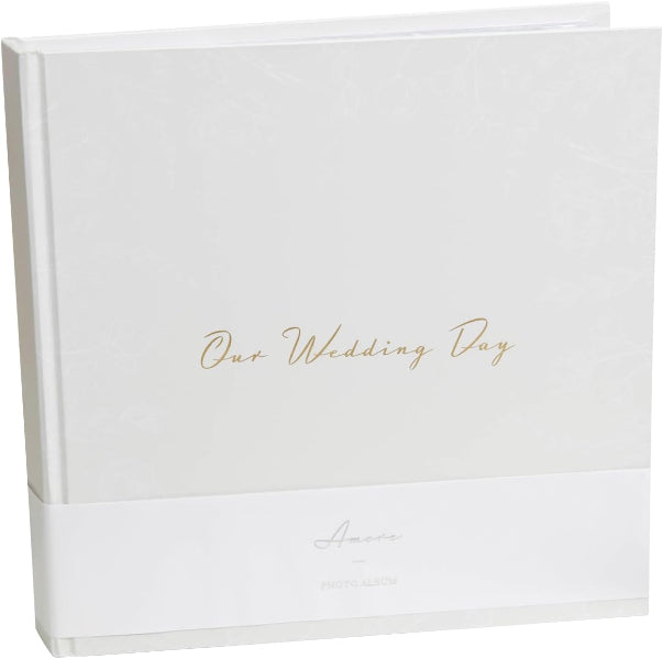 White album with 'Our Wedding Day' text in gold on a white background