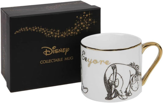Disney collectible mug with gold trim and black and white design, next to a black Disney box.