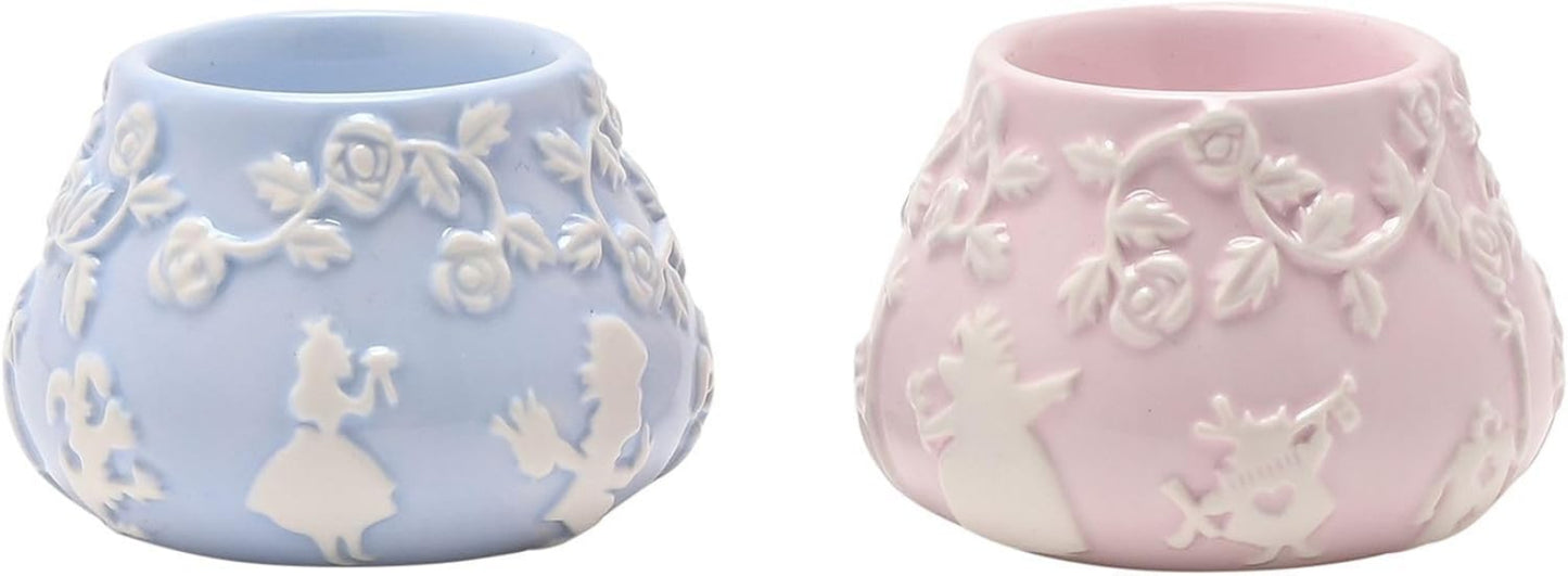 Two ceramic planters, one blue and one pink, with floral designs.