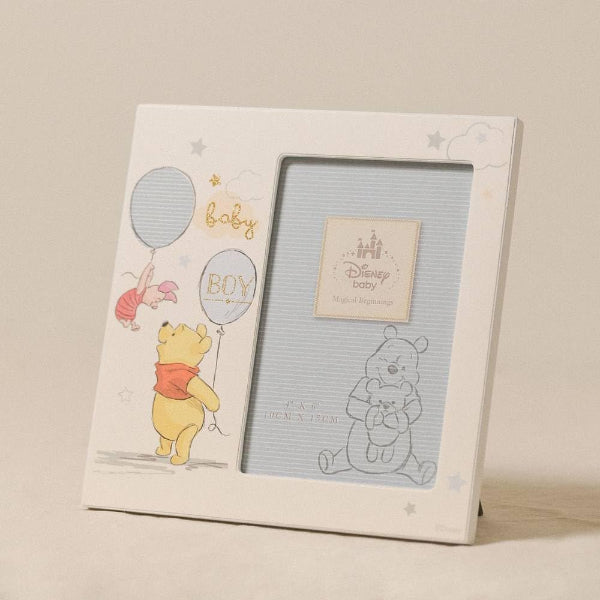 Baby photo frame with Winnie the Pooh design on a beige background