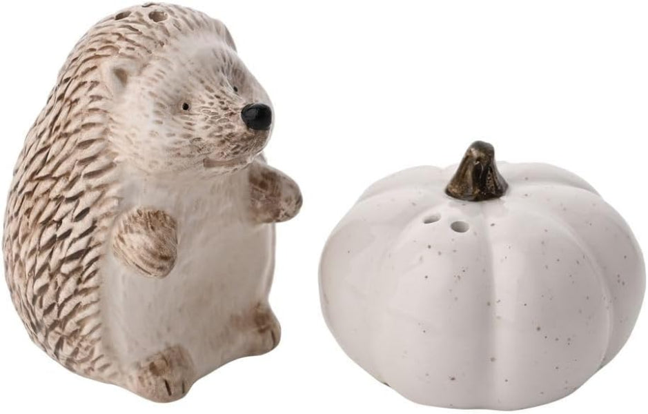 Decorative hedgehog and pumpkin figurines on a white background