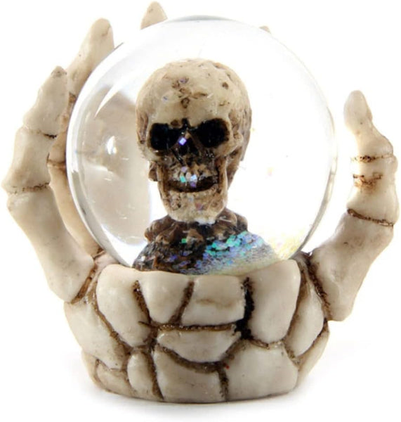 Glowing skeleton figure inside a crystal ball held by skeletal hands on a white background
