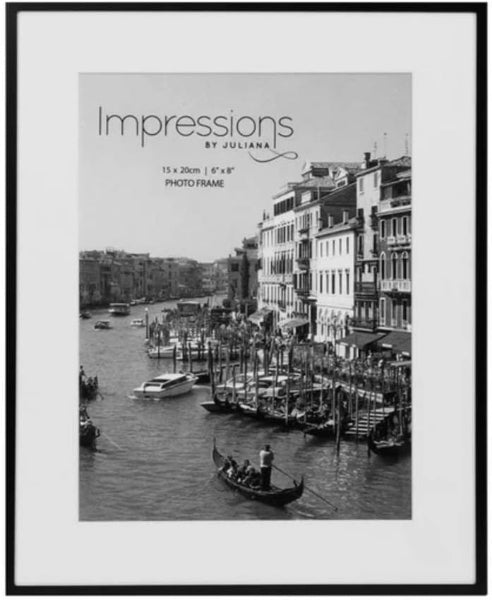 Framed photo of a canal scene with buildings and boats, featuring 'Impressions by Juliana' branding.