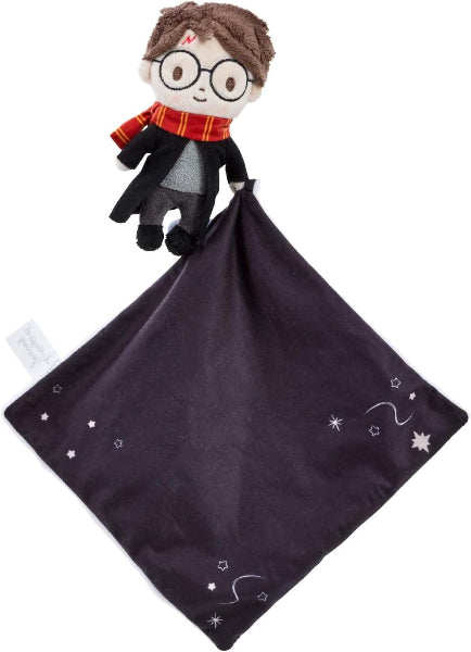 Plush toy resembling a character from a popular franchise on a dark purple blanket with star patterns.