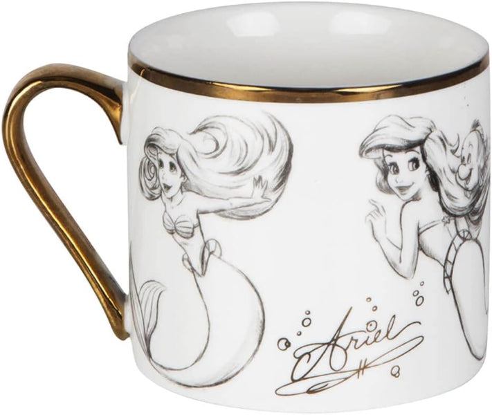 Mug with illustrations of a mermaid and gold handle on a white background.