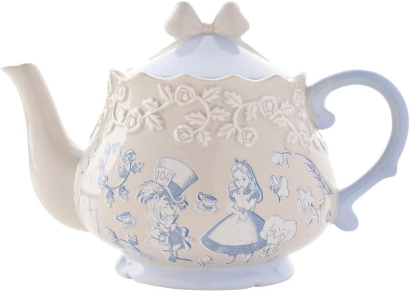 Decorative teapot with Alice in Wonderland design on a white background