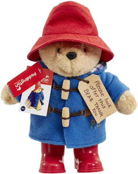 Paddington Bear toy with red hat, blue coat, and red boots on a white background