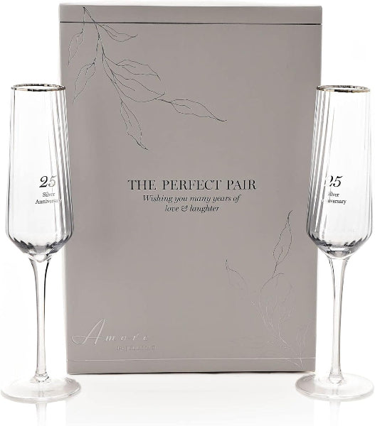 Two champagne flutes with 'The Perfect Pair' inscription in front of a matching gift box.