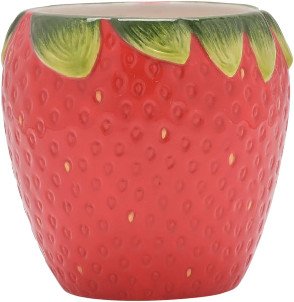 Ceramic strawberry-shaped container with red body and green leaves on a white background