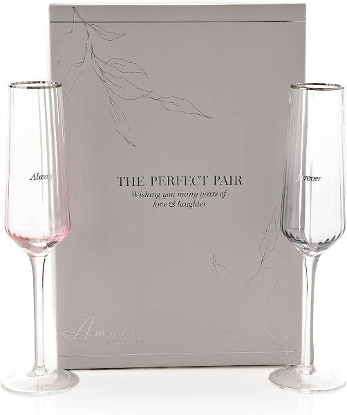 Two champagne flutes with a decorative box labeled 'The Perfect Pair' on a white background.