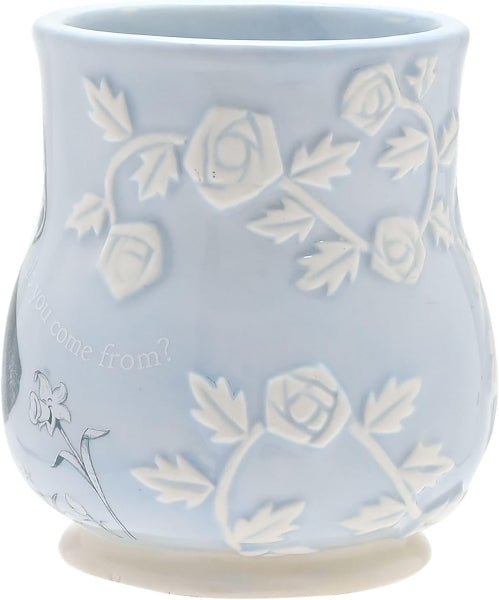 Light blue ceramic mug with white floral patterns on a white background