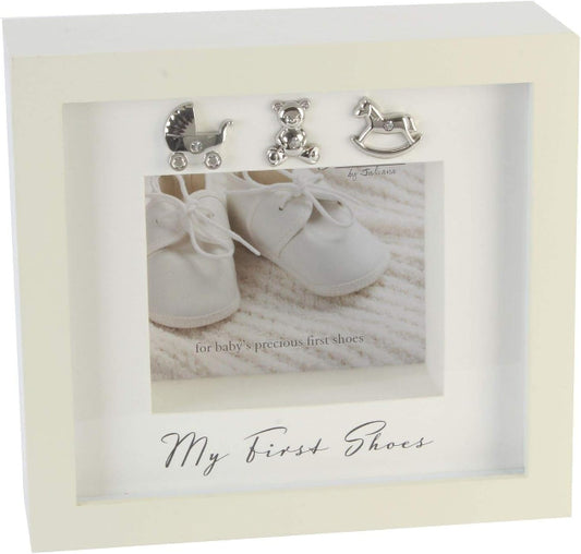 Decorative box with baby shoes and toys on a textured surface, featuring 'My First Shoes' text.