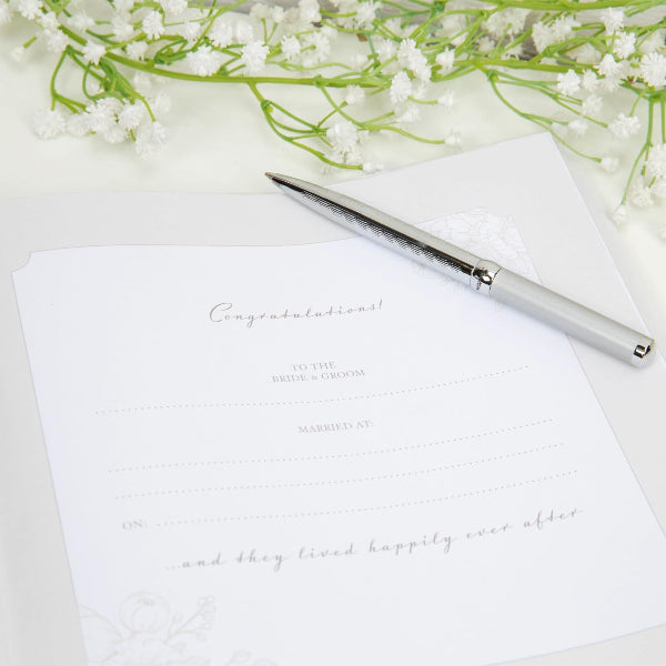 Wedding card with pen and flowers on a white background