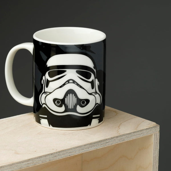 Mug with a stormtrooper helmet design on a wooden block against a dark background