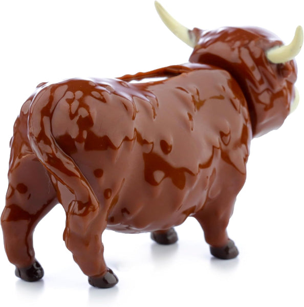 Brown bull figurine with white horns on a white background