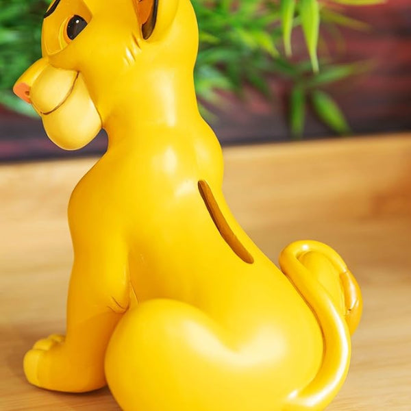 Yellow dog-shaped piggy bank on a wooden surface with a blurred green plant background
