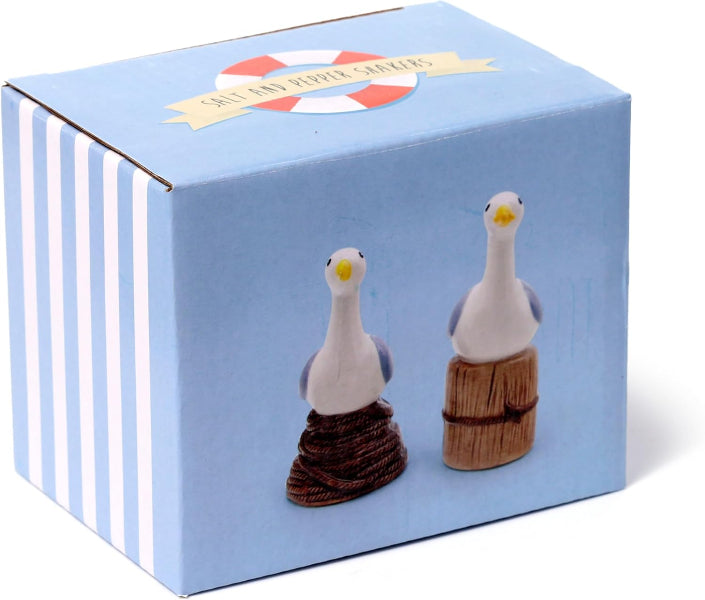 Salt and pepper shakers in the shape of seagulls on a box with a blue and white striped pattern.