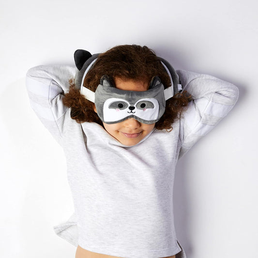 Person wearing a gray animal-themed sleep mask and hood on a white background