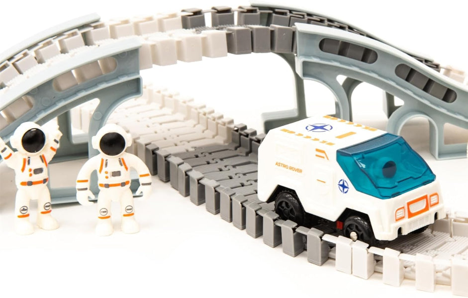 Toy car on a track with two astronaut figures in the background