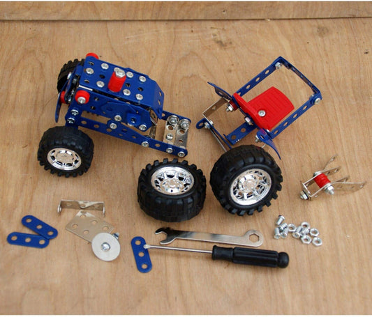 Children's toy car set with wheels, tools, and parts on a wooden surface