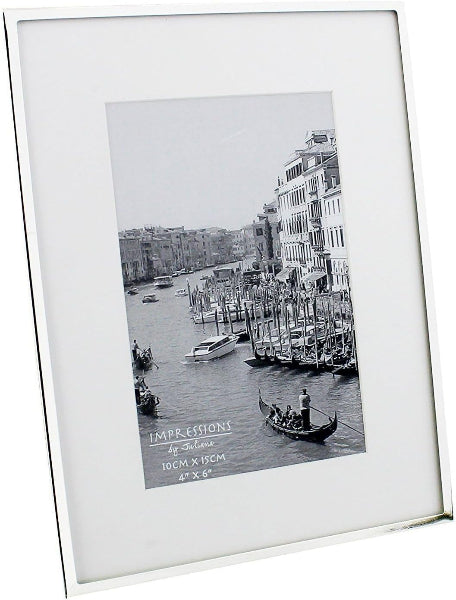 White picture frame with a black and white photo of a canal scene with boats and buildings.