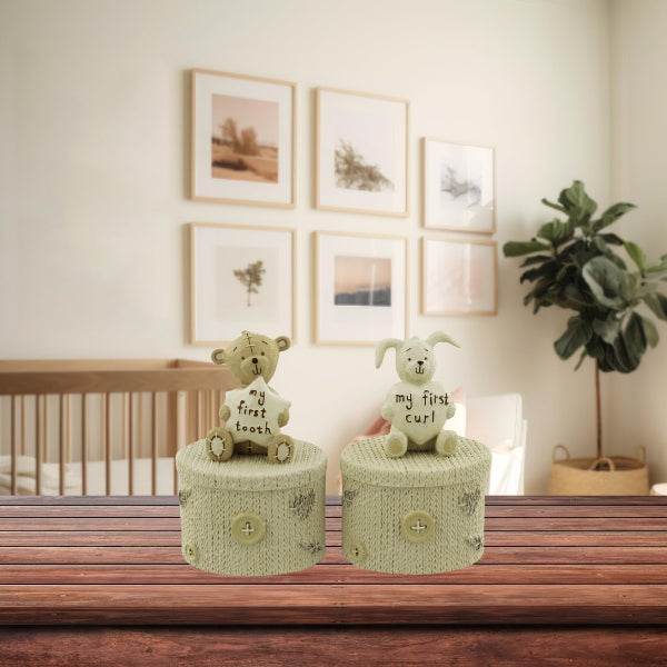 Two decorative boxes with teddy bears on top in a nursery setting.