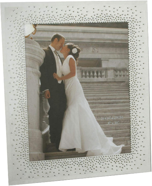 Wedding photo of a couple in a decorative frame with rhinestone embellishments.