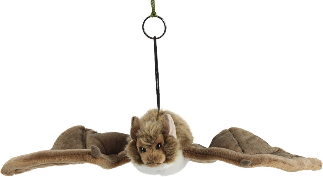 Plush toy bat hanging from a string on a white background