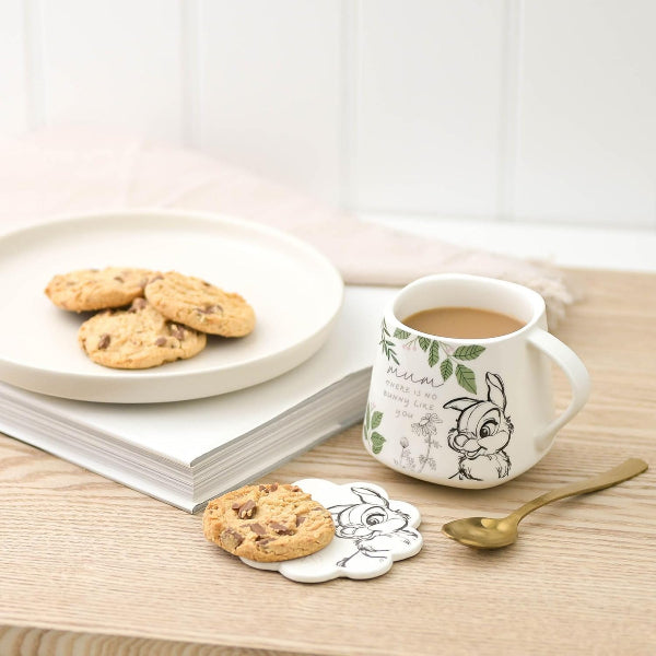 Cup of coffee with cookies and a book on a wooden table