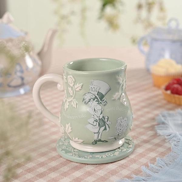 Green mug with decorative design on a tablecloth