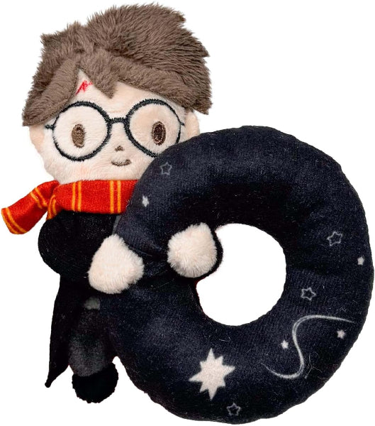 Plush toy resembling a character with glasses and a scarf, holding a black ring with star patterns on a white background.