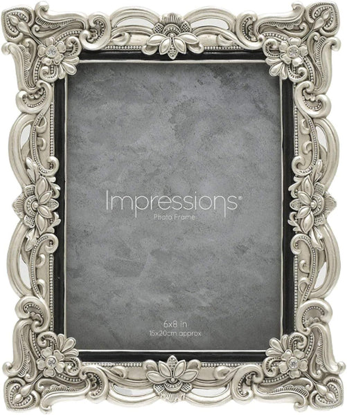 Decorative silver photo frame with 'Impressions' branding on a gray background