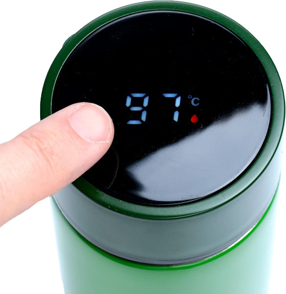 Green thermos with digital temperature display showing 97 degrees Celsius, being touched by a finger.