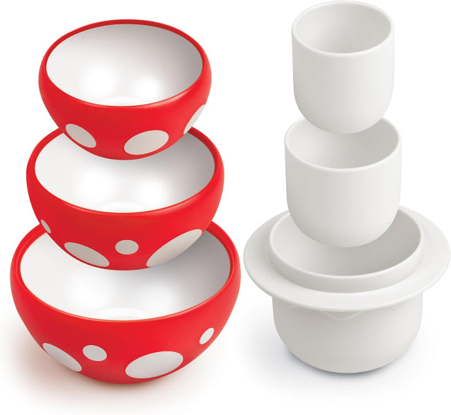 Set of red and white polka dot bowls with matching cups on a white background