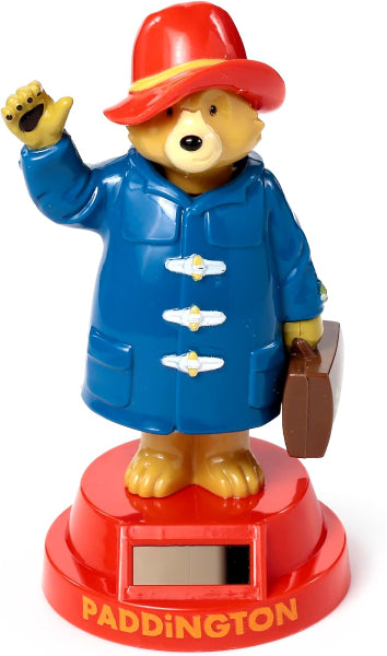 Toy figure of Paddington Bear waving with a red hat and blue coat on a white background.