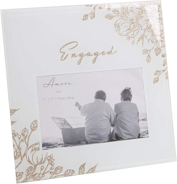 Engaged photo frame with floral design and couple sitting by a lake
