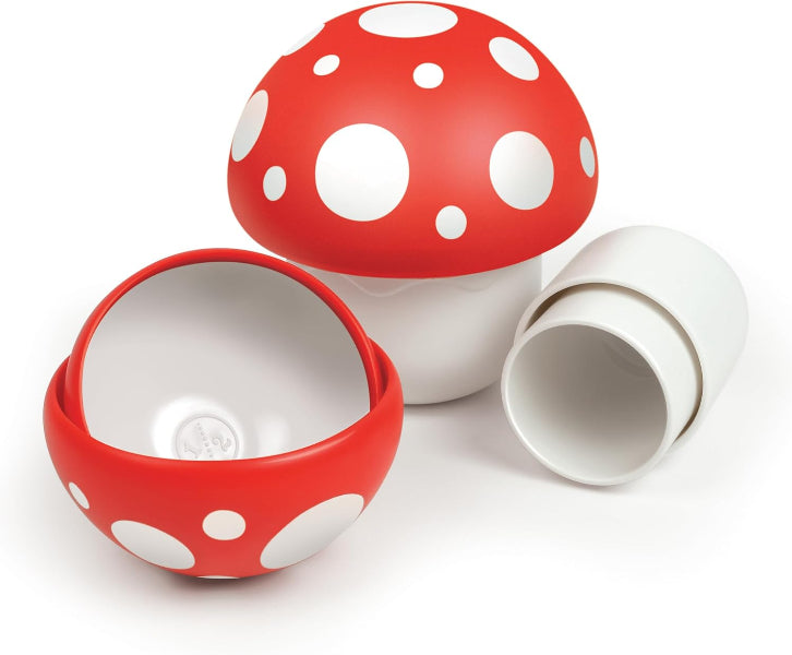 Red and white polka dot mushroom-shaped container on a white background