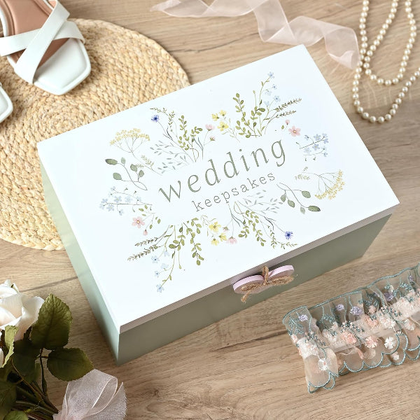Wedding keepsakes box with floral design on a wooden surface