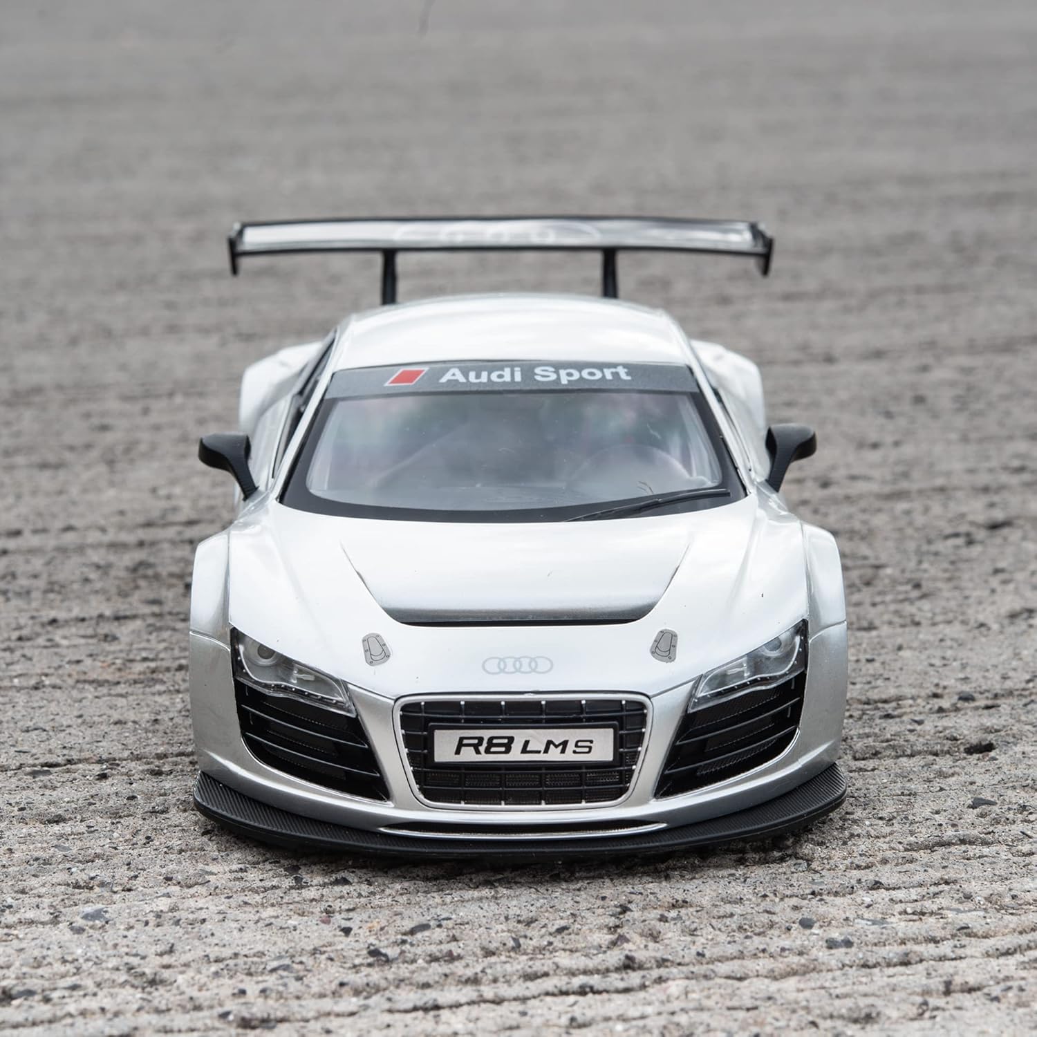 White Audi R8 LMS sports car on a gray surface
