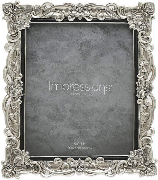 Decorative silver photo frame with 'Impressions' branding on a gray background