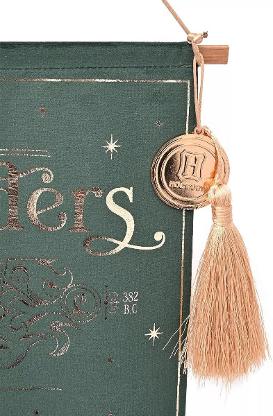 Decorative book with gold text and tassel on a green background