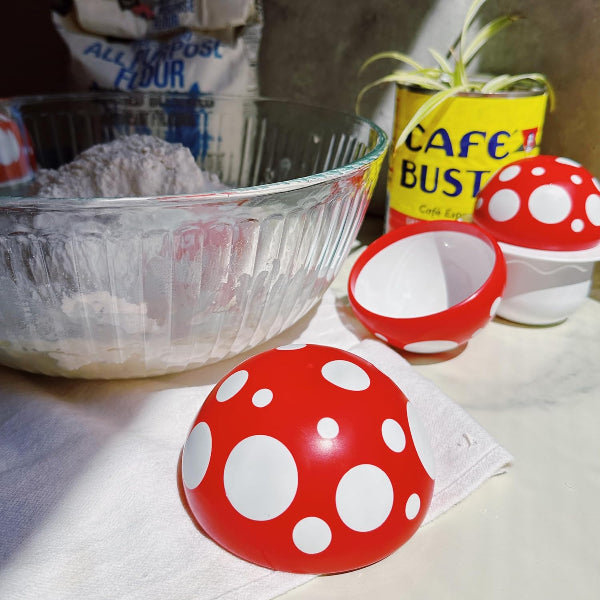 Red and white polka dot containers on a kitchen counter with flour and Cafe Bustelo coffee in the background.