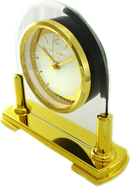 Gold clock with clear dome on a white background