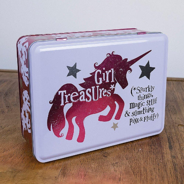 Tin box with a unicorn design and text on a wooden surface