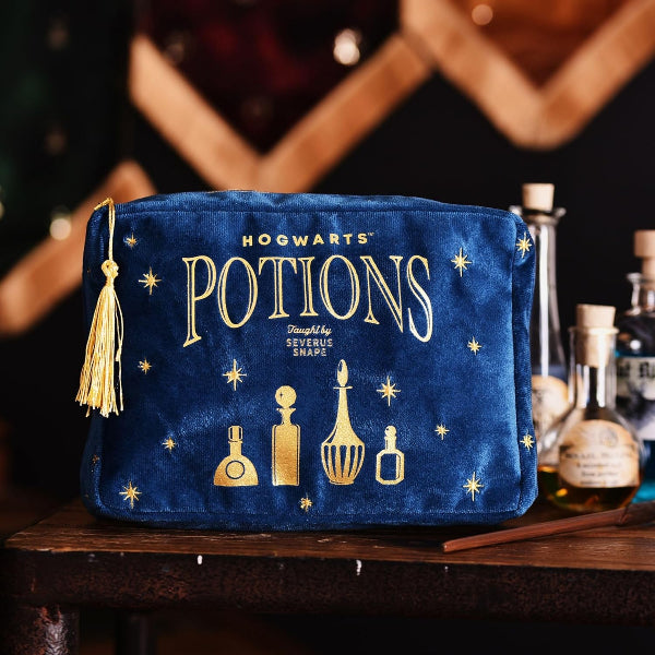 Blue pouch with 'Hogwarts Potions' text and gold illustrations on a wooden surface.
