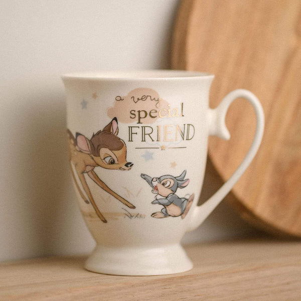 Mug with cartoon characters and 'a very special friend' text on a wooden surface.