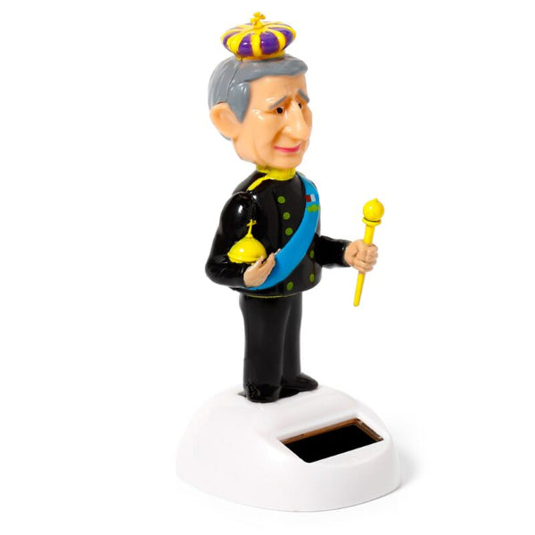 Toy figure of a character in formal attire with a crown, holding a scepter, on a white background.